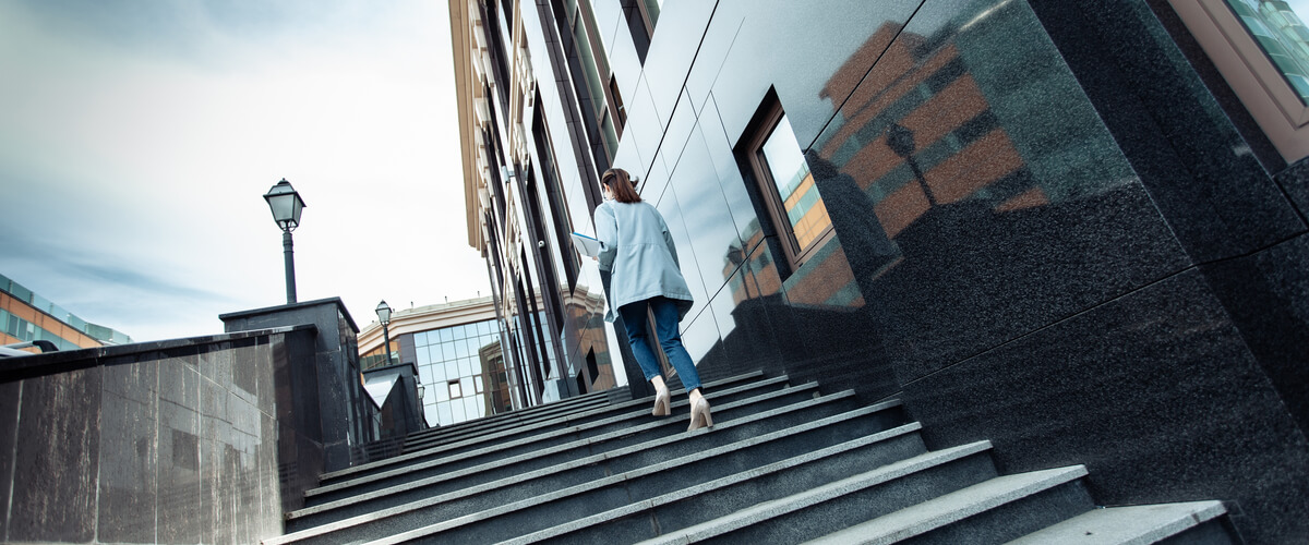 Business woman walking up stairs
