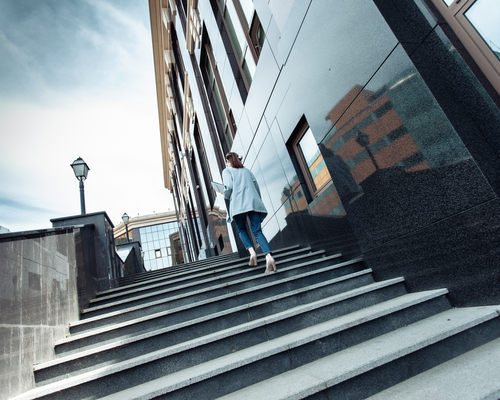 Business woman walking up stairs