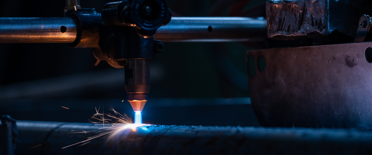 Plasma cutting pipe operator cuts torch